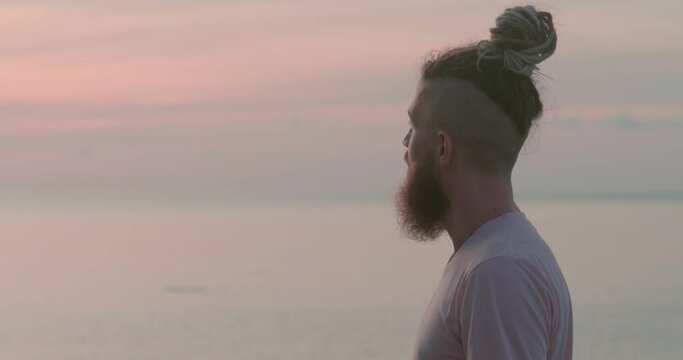 Observing ocean man with beard thinking head back view Reflections on meaning life amidst summer serenity. Reflections on meaning life journey to self Reflections on meaning of life in close-up.