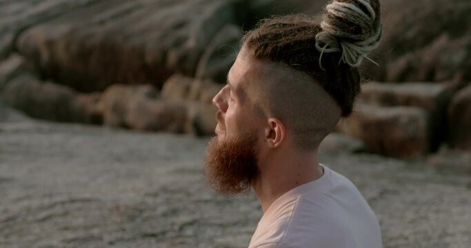 Man with beard meditating sea beach side view eyes closed close-up Seeking inspiration in solitude. Inspiration key to mental health and confidence Inspiration found in moments of tranquility.