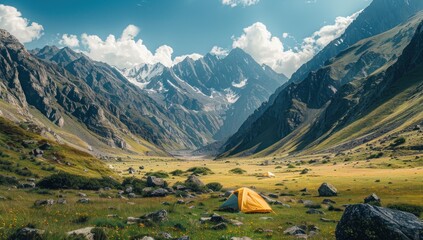 A campsite nestled in a valley, surrounded by towering mountains.