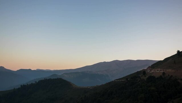 4K sunset to night Timelapse small village above mountains with milkeyway galaxy