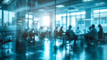Blurred offices with people working behind glass walls