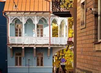 vivid blue building in Tbilisi, showcasing intricate lace-like metalwork and traditional Georgian...