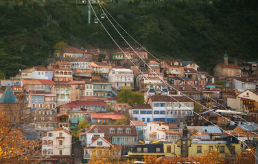 dense, layered architecture of Tbilisi's hillside neighborhoods where homes and buildings cluster...