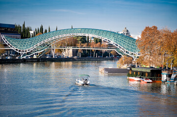  Peace Bridge, a modern architectural marvel, stretching across the Kura River in Tbilisi. The...