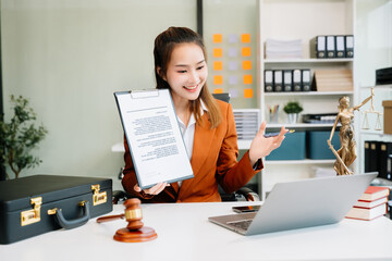 Asian woman lawyer working and gavel, tablet, laptop in front, Advice justice and law concept..