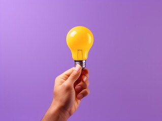 a hand holding a light bulb