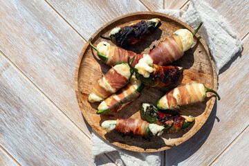 Jalapeno poppers. Spicy peppers stuffed with cream cheese and wrapped in bacon