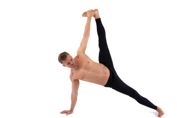 A handsome young man with an athletic body is doing fitness and yoga. White background.