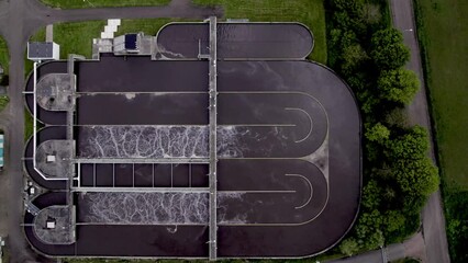 Top down aerial water treatment facility in The Netherlands. Clean tap water infrastructure filtering basin circular waste management.