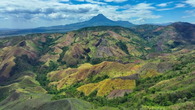Beautiful Green Landscape of Philippines with road and green plants during sunny day. Large Matutum Mountain Volcano in background. Panorama view.