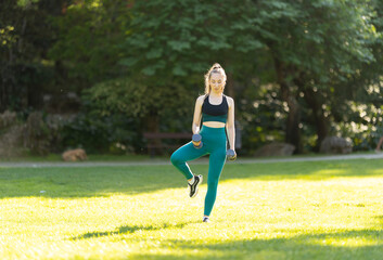 A woman is exercising in a park