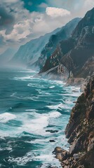 A breathtaking view of the vast ocean stretching out towards towering mountains, with waves crashing against the rocky shore 