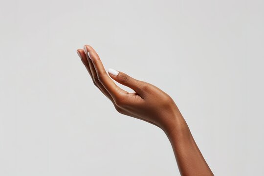 Elegant dark-skinned hand gesture isolated on light background - Powered by Adobe