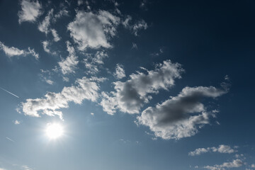 bright sun and white clouds at blue sky
