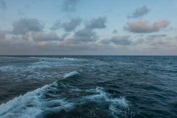 strong high waves at the sea with clouds at the sky