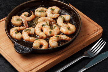 a pan of shrimp on a cutting board