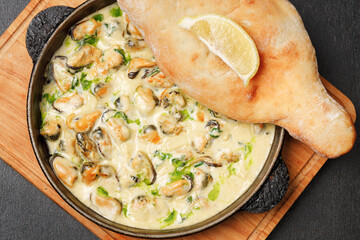 a pan of food with a lemon wedge