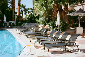 Swimming pool and sun loungers at stylish tropical spa hotel, summertime banner mockup. Summer...