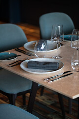 Restaurant table setting. Details of high end dining. close up of luxury plates and cutleries on restaurant table. 