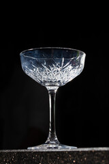 Close up of wine glass on black background. Abstract beverage background. Drink culture.