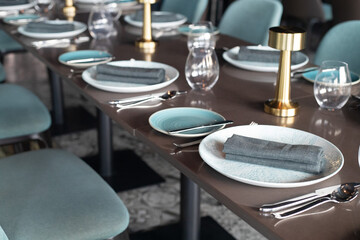 Restaurant table setting. Details of high end dining. close up of luxury plates and cutleries on restaurant table. 