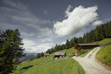 Some old isolated houses over a mountain pasture in Dolomites with wonderful panorama