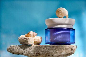 White blue jar with skincare product. Summer decorations with seashell around cosmetology bottle....