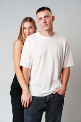 Obraz premium A Man and a Woman Standing Next to Each Other in studio