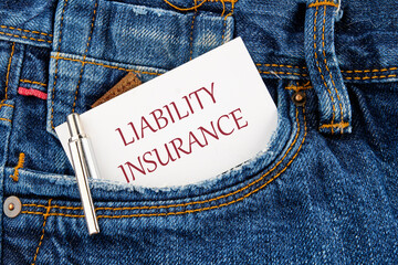 Text Liability Insurance on a business card peeking out of a jeans pocket