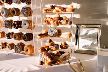 A donut wall set up for a wedding reception. An assortment of a variety of delicious glazed...
