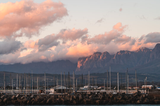 Sunset light hitting the Hottentots holland mountains with Gordons bay harbor in the forefront