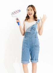 Appealing Asian woman holds paintbrushes on white background.