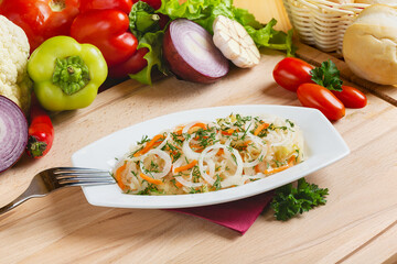 Sauerkraut with onions, appetizer for vodka on a plate, lunch, cafe.