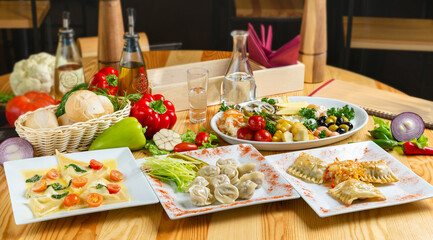 Assorted dumplings and snacks to go with vodka on a plate, lunch, cafe.