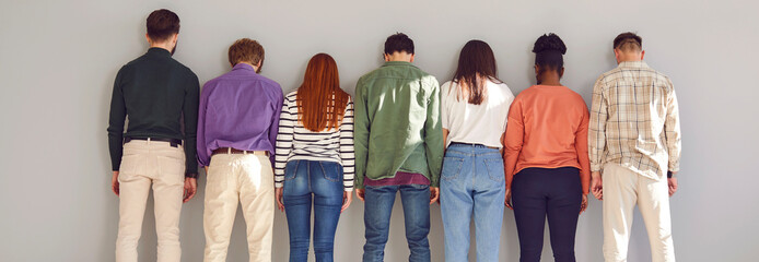 Back portrait of multiethnic diverse group of a young people friends or colleagues wearing casual...