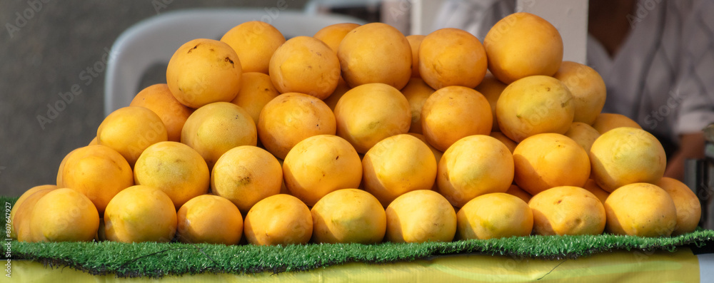 Sticker yellow mango on a counter in a market