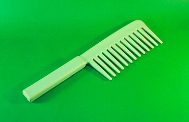 Hair comb isolated on green screen background. Beautiful woman hair comb isolated close up view.