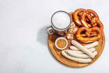 Traditional Oktoberfest set. Pretzels, beer, weisswurst with mustard. German festival food concept