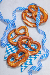 Traditional Oktoberfest Pretzels. German festival food concept. Trendy hard light, dark shadow