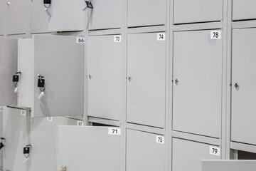 Metal luggage storage at shopping mall. Safe lockers in public place. Locker room with  numbered boxes. Private safety in supermarket. Secure in gym. Safe storage background.  