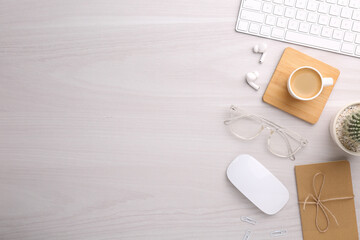 Flat lay composition with different office stationery on white wooden table, space for text