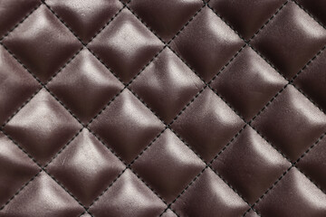 Naklejka premium Brown natural leather with seams as background, top view