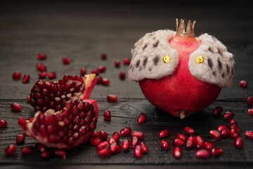 Concept, pomegranate as the king of fruits with a golden crown. Metaphor, a leader leading behind...