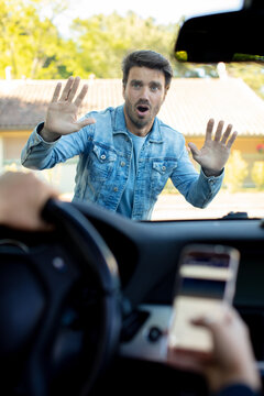 man that is texting while driving runs over a pedestrian