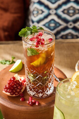 Refreshing Pomegranate Lemonade with Cilantro and Narsharab Sauce in an Elegant Glass, Served on a Rustic Table