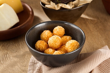 Young Woman Preparing Cheese Tempura Balls in Modern Kitchen, Focused on Cooking Task, Daytime Casual Setting