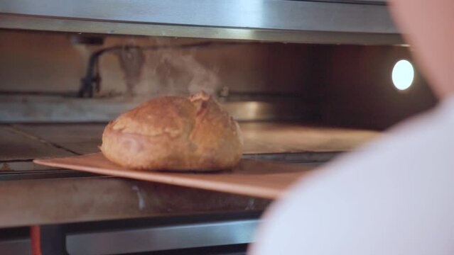 Fresh steaming hot baked bread right out of the oven in bakery