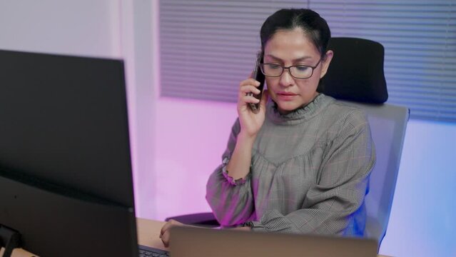 Close-up A stressed-out female coder calls a startup friend to find a solution to a broken code problem.