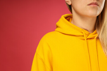 A young woman in a yellow hooded sweatshirt