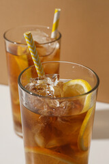 Glasses of cold tea with an orange